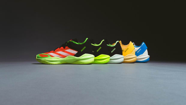 Side view of multicolor adidas basketball sneakers.